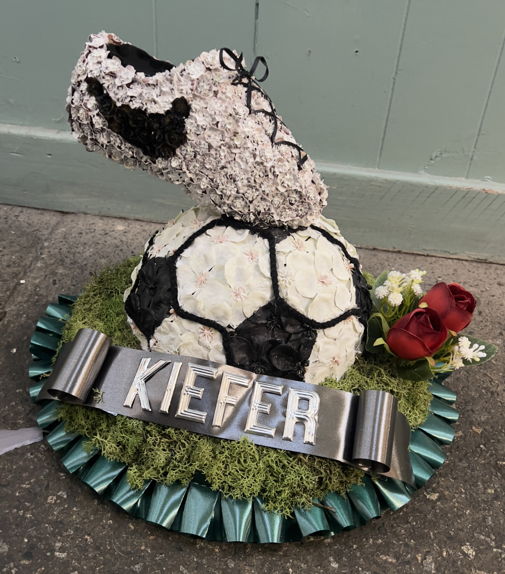 Football boot on football funeral tribute